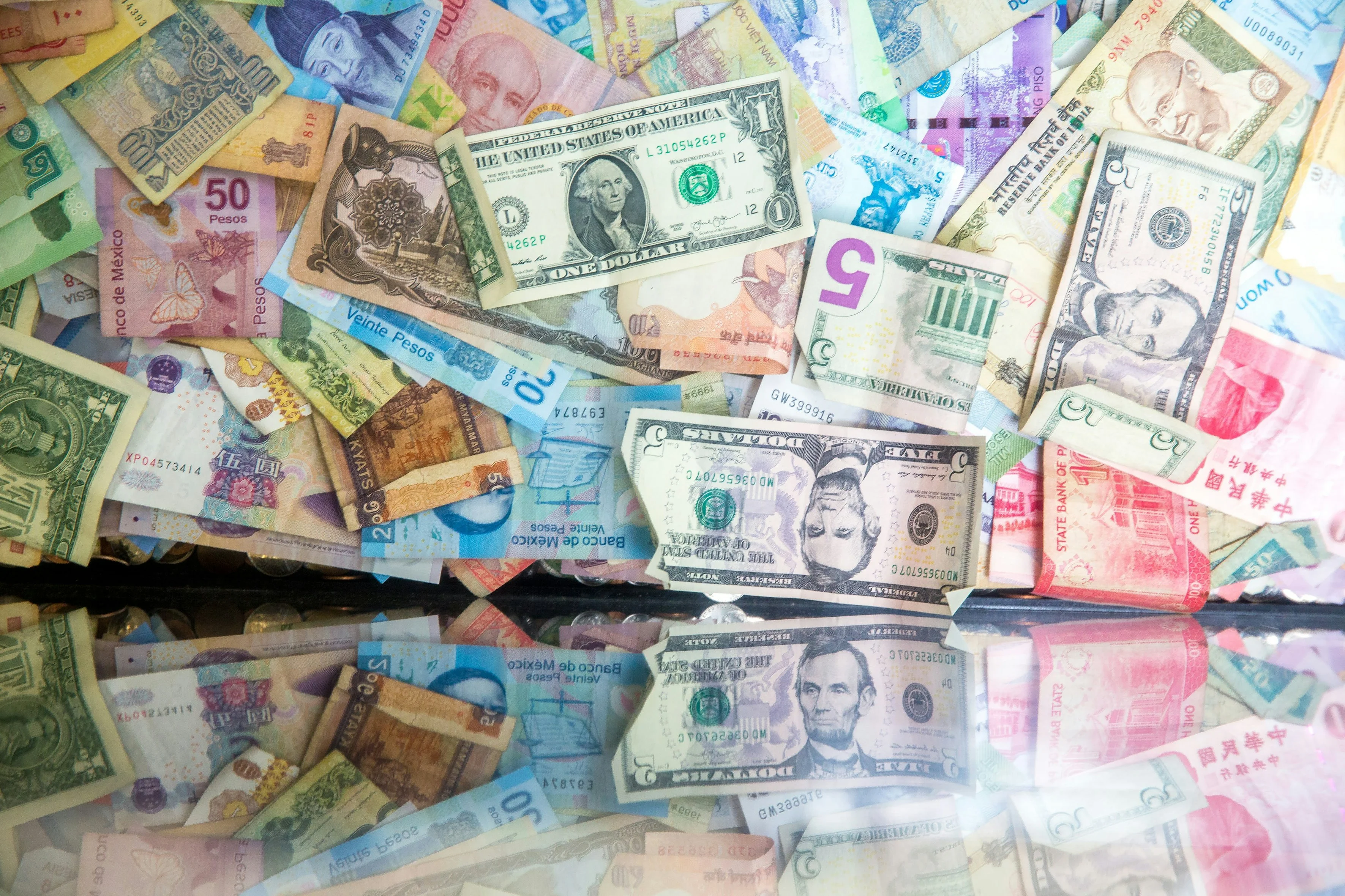 Visual representation of currency hedging with international currency symbols and protective shield