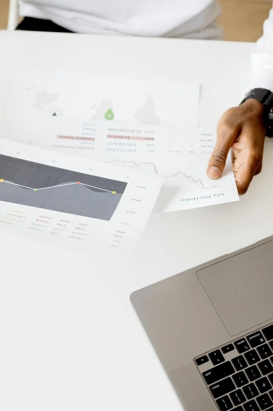 Financial charts and economic data visualization with growth projection arrows, representing economic forecasting analysis