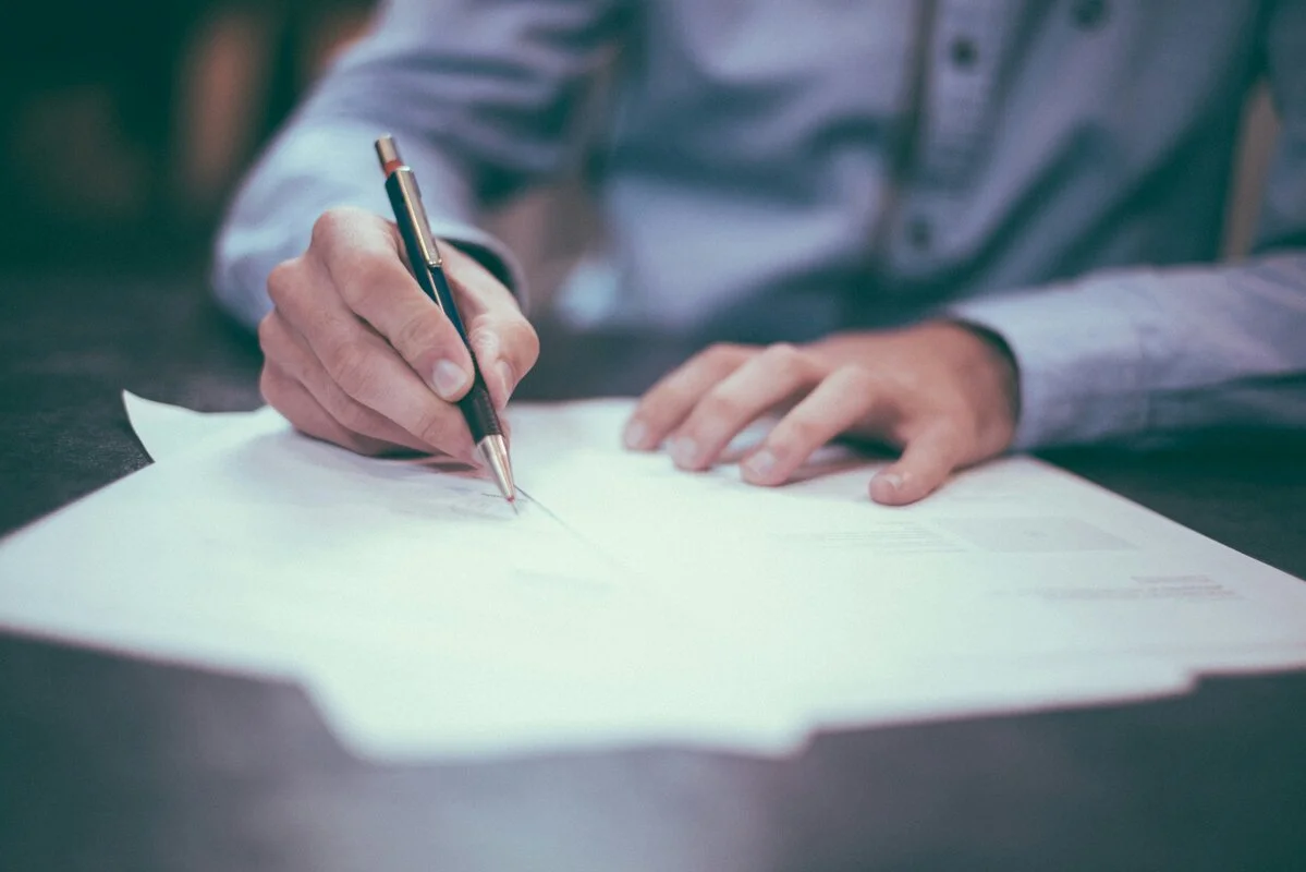 Legal documents, family photos, and financial statements on a desk, representing the comprehensive nature of thoughtful estate planning